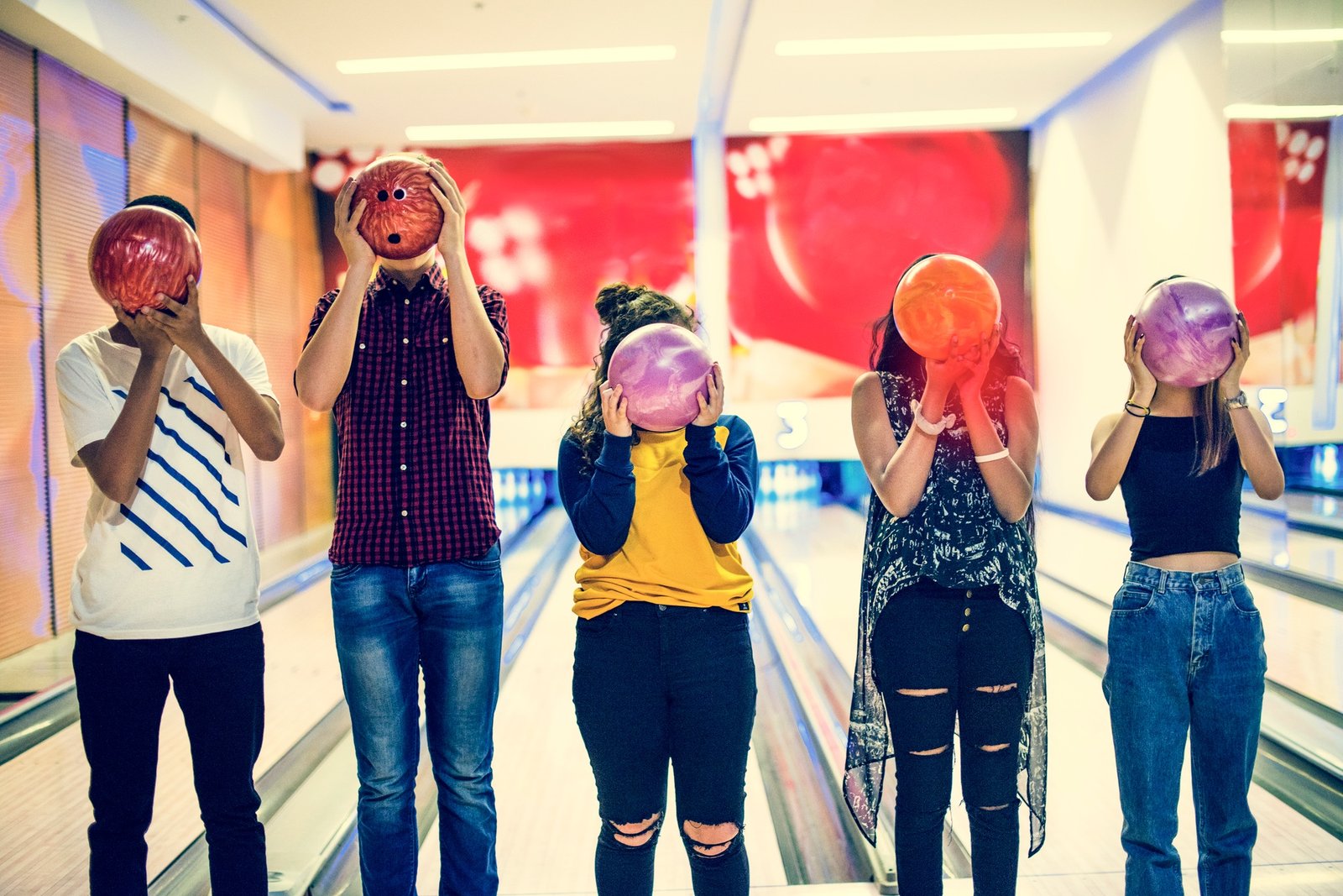 Friends bowling together indoors